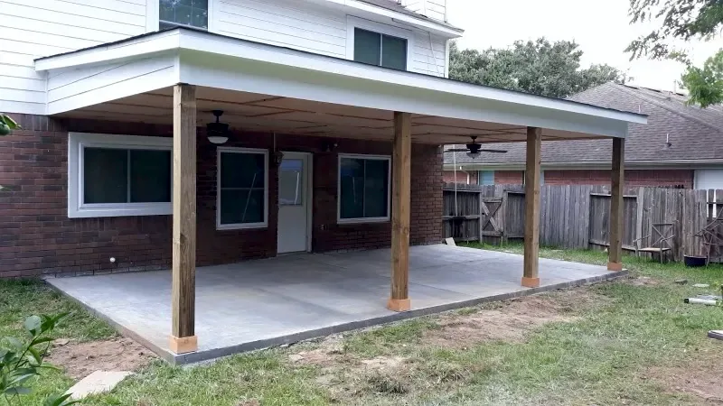 Same backyard with a new covered patio and concrete slab by Brown Sterling Builders