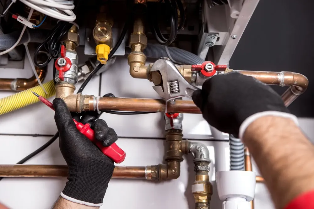 Brown Sterling Builders technician repairing copper water lines
